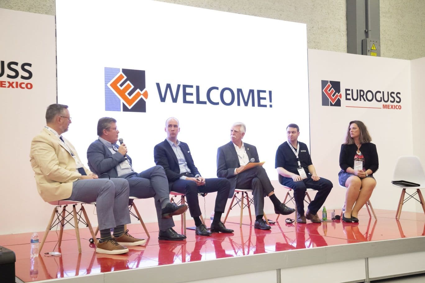 Business men sit on a stage at EUROGUSS Mexico